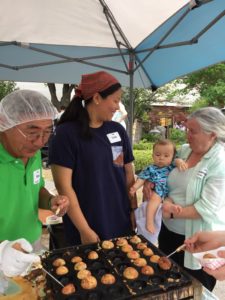 Volunteers cooking octopus balls