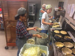 Volunteers cooking pancakes